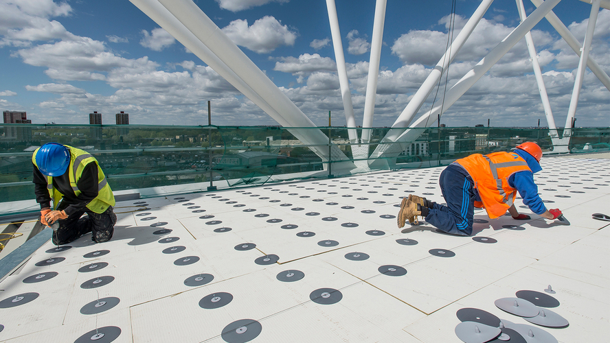 Operatives working on a large roof under inspection and installation conditions