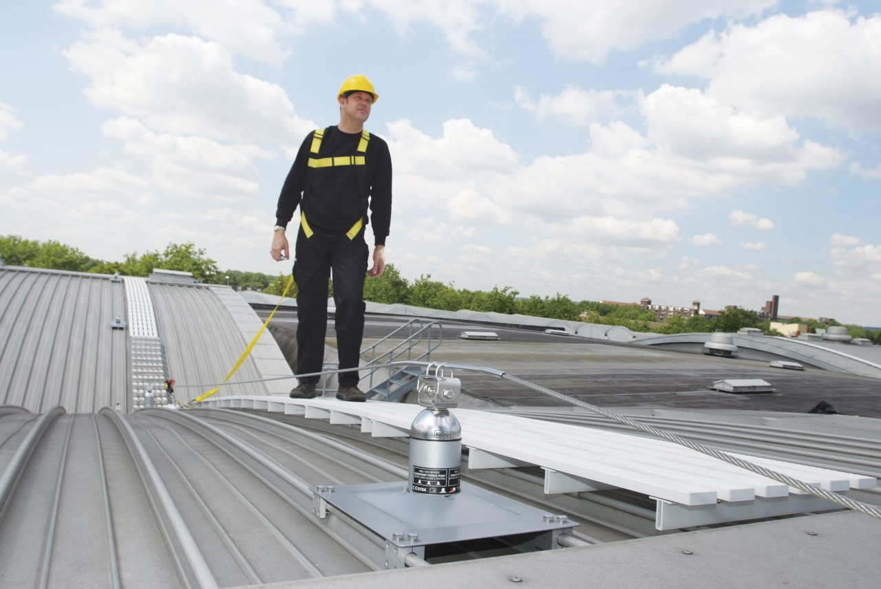 Operative on a rooftop walkway clipped to a Latchways post
